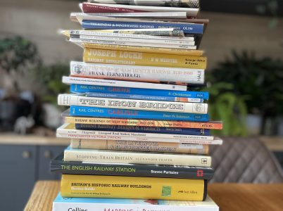 A stack of approximately 30 railway heritage books.